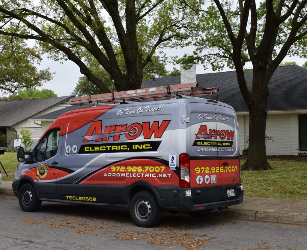 Arrow Electric service van parked on a residential street, with company branding and contact details.