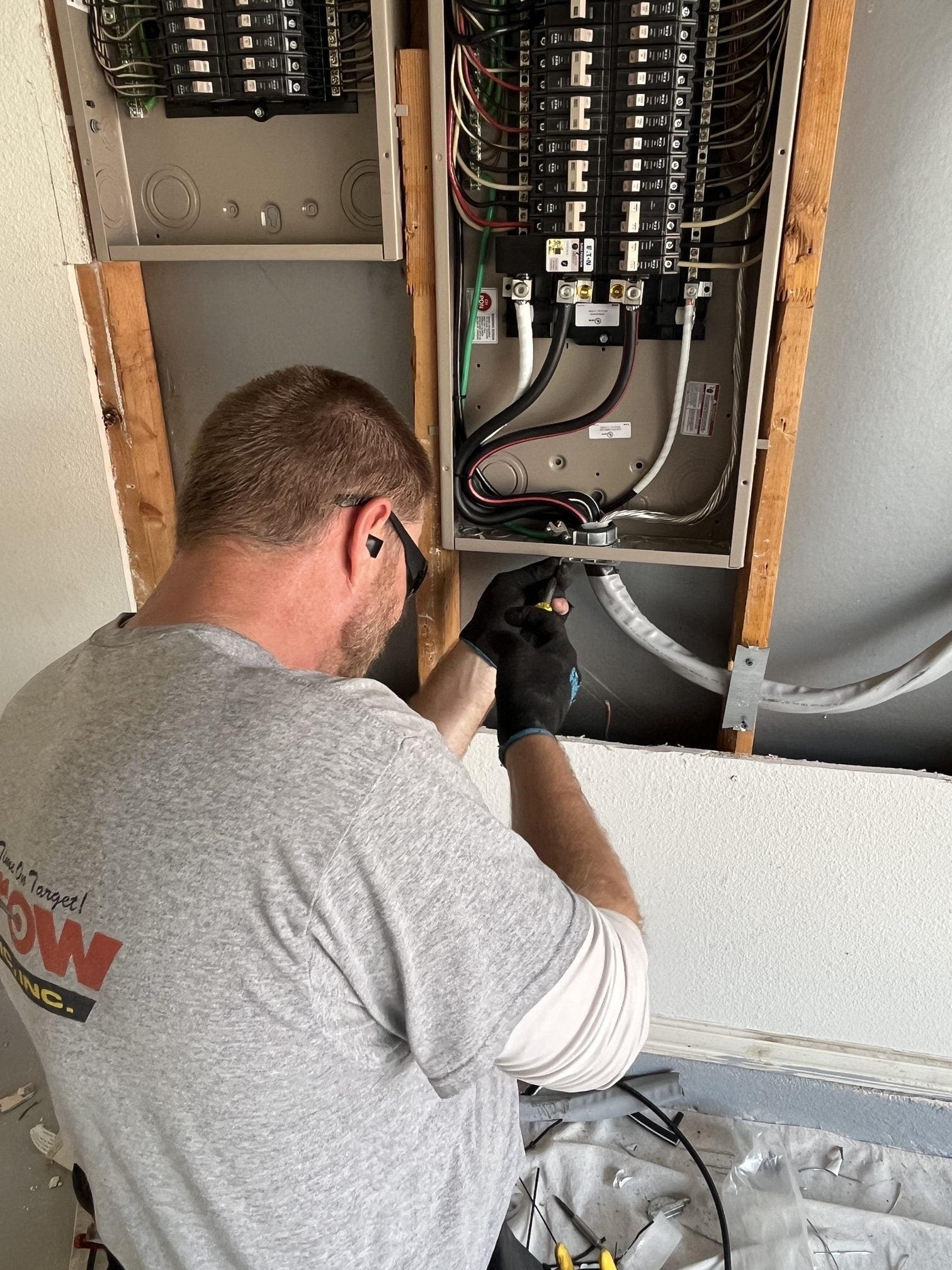 Arrow Electric technician working on an electrical panel installation.